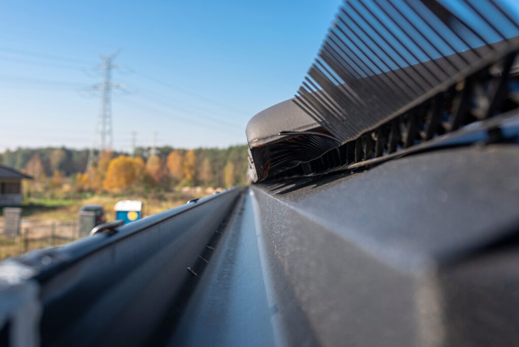 a-metal-black-gutter-on-a-roof-covered-with-ceram-2023-11-27-05-08-41-utc